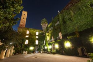 Evening view of the courtyard and tower at Palazzo De Gregorio in Palermo, Sicily.