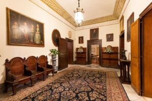 Historic interiors and family portraits inside Palazzo De Gregorio, Palermo, Sicily.